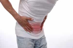 Man holding stomach in pain, showing symptoms of digestive issues or urinary tract infection.